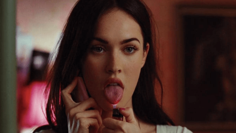 Megan Fox as Jennifer from "Jennifer's Body" holds a cellphone to her ear and holds the flame of a lighter to the tip of her tongue killer women