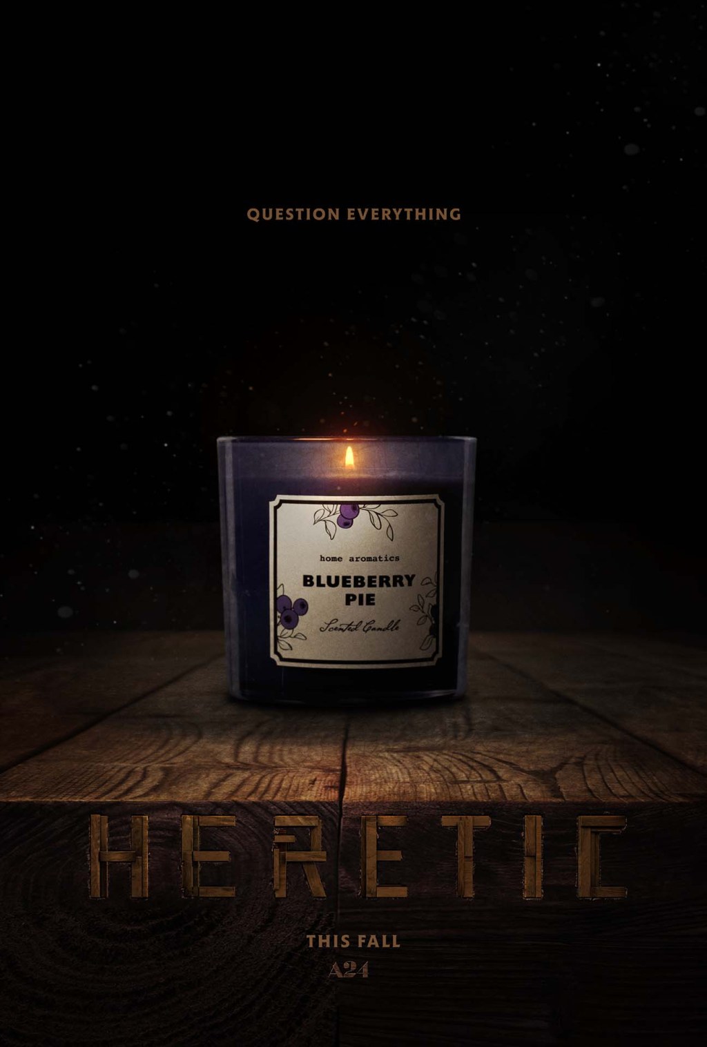 Heretic (2024) Poster depicts a hardwood table disappearing into the darkness with the word Heretic carved into the edge of the wood table, A single candle in a glass jar with a label that reads "Blueberry" lights the scene.